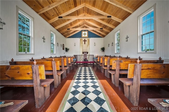 interior space with wooden ceiling, wood finished floors, and vaulted ceiling with beams