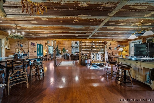 interior space with wooden walls and hardwood / wood-style floors