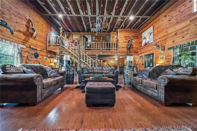 living room with wood walls, hardwood / wood-style floors, and a healthy amount of sunlight