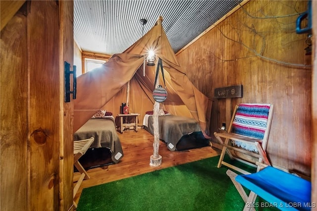 129 Vaughan Rd, Eldon, MO 65026 - bedroom with wooden walls and wood finished floors