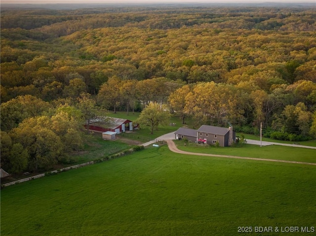 drone / aerial view with a wooded view and a rural view