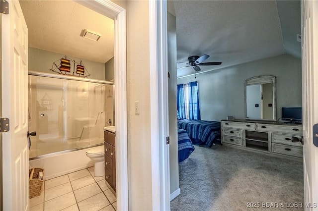 full bathroom with connected bathroom, ceiling fan, tile patterned flooring, vanity, and enclosed tub / shower combo