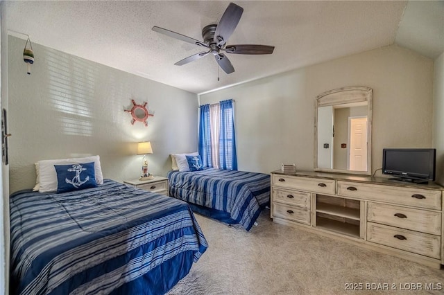bedroom featuring a ceiling fan, vaulted ceiling, and carpet