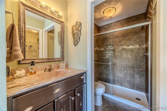 full bathroom with vanity, toilet, tile patterned flooring, and a stall shower