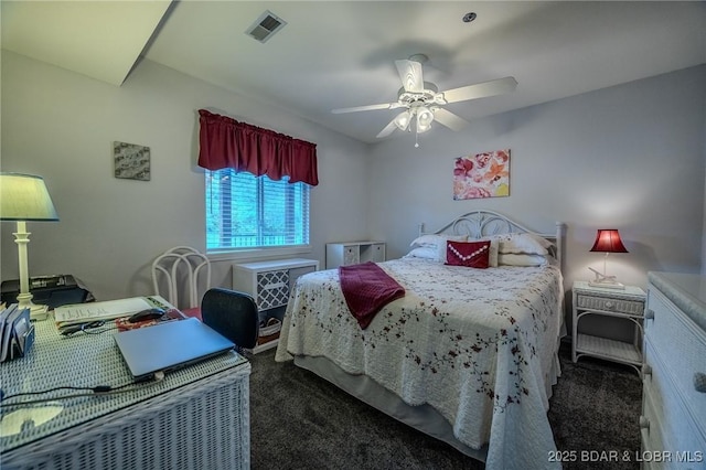carpeted bedroom featuring ceiling fan and visible vents