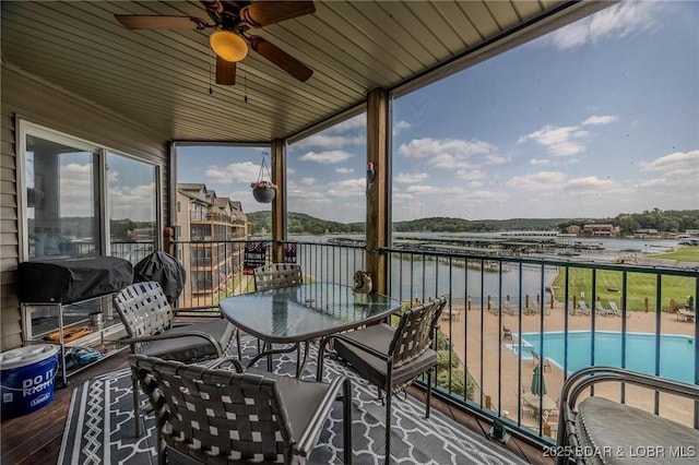 balcony featuring a water view, area for grilling, and ceiling fan