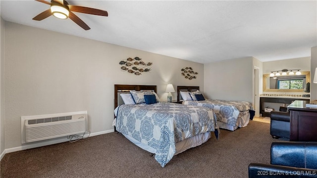 bedroom with carpet floors, ceiling fan, a wall unit AC, and ensuite bath