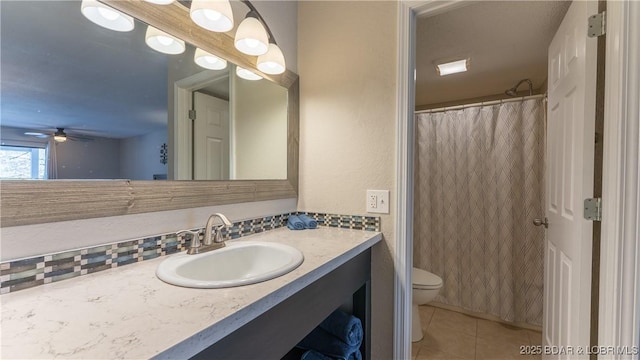 full bathroom with ceiling fan, tile patterned flooring, vanity, toilet, and backsplash