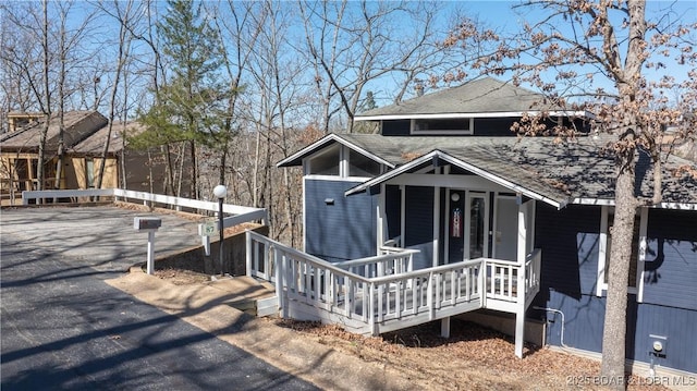 view of front of property with covered porch and a shingled roof