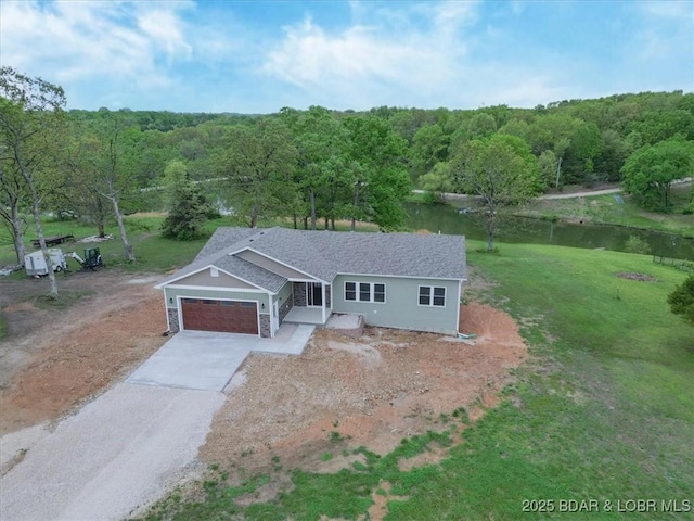 21 Meadow Lake Cir, Eldon, MO 65026 - ranch-style home featuring driveway, an attached garage, a front lawn, a view of trees, and a water view