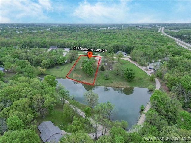 21 Meadow Lake Cir, Eldon, MO 65026 - aerial view of property and surrounding area featuring a nearby body of water, property parcel outlined, and a forest
