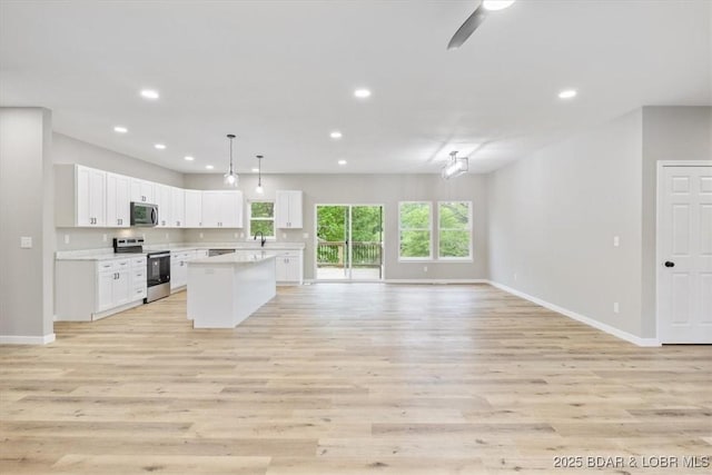 21 Meadow Lake Cir, Eldon, MO 65026 - kitchen featuring appliances with stainless steel finishes, open floor plan, baseboards, and recessed lighting