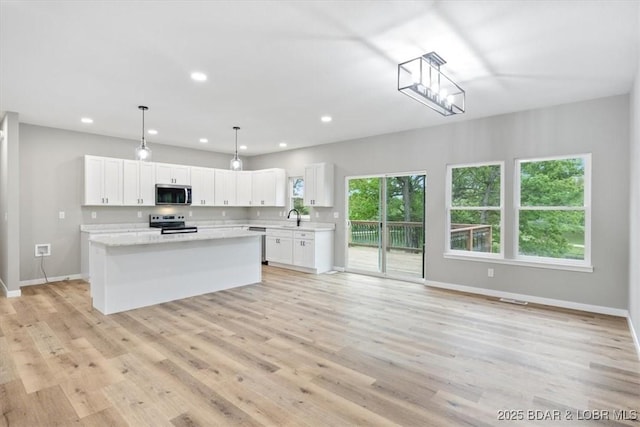 21 Meadow Lake Cir, Eldon, MO 65026 - kitchen featuring stainless steel appliances, a sink, light countertops, baseboards, and recessed lighting
