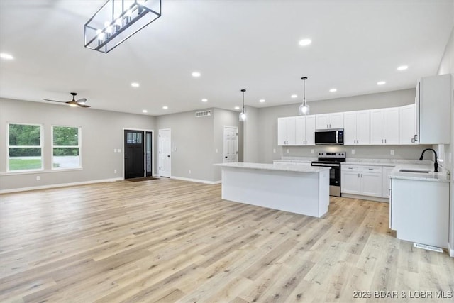 21 Meadow Lake Cir, Eldon, MO 65026 - kitchen featuring appliances with stainless steel finishes, a sink, a center island, recessed lighting, and open floor plan