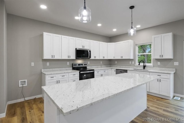 21 Meadow Lake Cir, Eldon, MO 65026 - kitchen with appliances with stainless steel finishes, baseboards, a sink, white cabinetry, and light wood finished floors