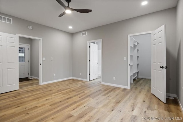 21 Meadow Lake Cir, Eldon, MO 65026 - unfurnished bedroom featuring a walk in closet, light wood-style floors, recessed lighting, and baseboards
