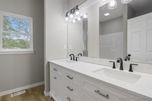 21 Meadow Lake Cir, Eldon, MO 65026 - bathroom with wood finished floors, double vanity, baseboards, and a shower