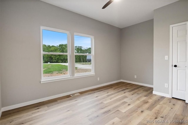 21 Meadow Lake Cir, Eldon, MO 65026 - unfurnished room with ceiling fan, baseboards, and light wood-type flooring