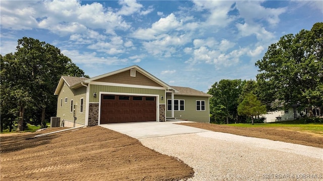 21 Meadow Lake Cir, Eldon, MO 65026 - view of front of home with stone siding, concrete driveway, central AC unit, an attached garage, and board and batten siding