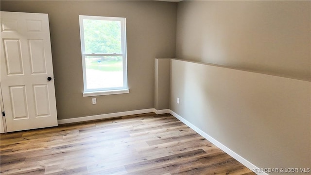21 Meadow Lake Cir, Eldon, MO 65026 - spare room featuring plenty of natural light, light wood-style flooring, and baseboards