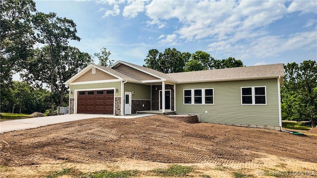 21 Meadow Lake Cir, Eldon, MO 65026 - view of front facade with concrete driveway, an attached garage, and stone siding