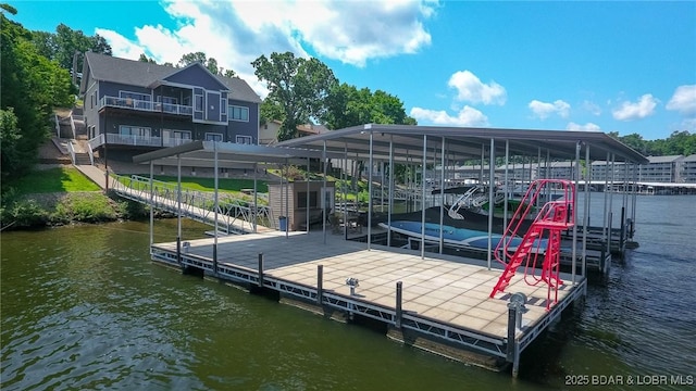 dock area with a water view and boat lift
