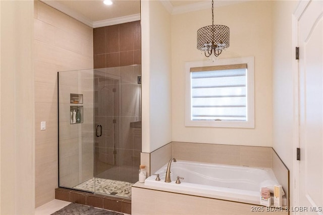 bathroom with an inviting chandelier, ornamental molding, a bath, and a stall shower