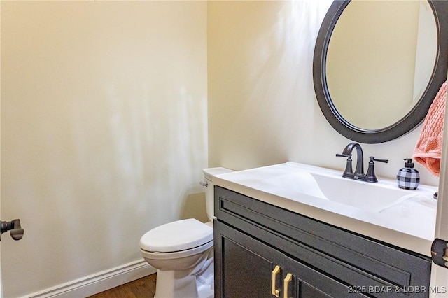 1484 Apple Blossom Cir, Osage Beach, MO 65065 - half bath featuring vanity, toilet, wood finished floors, and baseboards