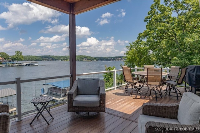 wooden terrace featuring a water view and outdoor dining area