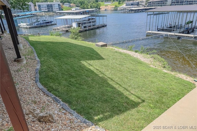 view of yard with a water view and a floating dock