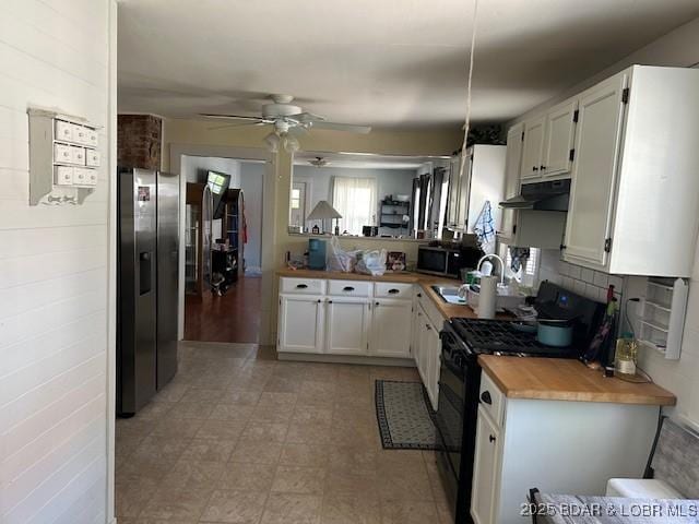 kitchen with a sink, white cabinetry, under cabinet range hood, a ceiling fan, and stainless steel appliances