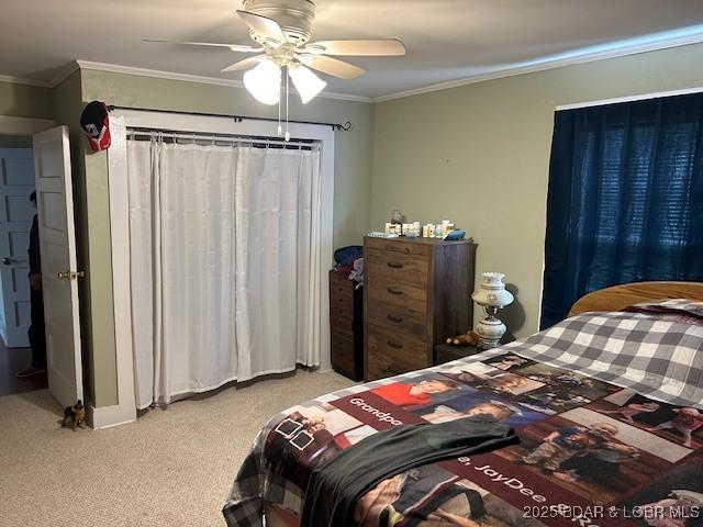 bedroom featuring a ceiling fan, baseboards, ornamental molding, and carpet