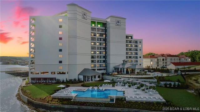166 Captiva Dr Unit 5B, Sunrise Beach, MO 65079 - property at dusk featuring a community pool and a water view
