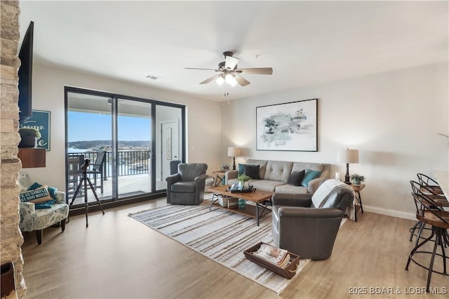 166 Captiva Dr Unit 5B, Sunrise Beach, MO 65079 - living room with baseboards, ceiling fan, wood finished floors, and visible vents