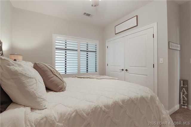166 Captiva Dr Unit 5B, Sunrise Beach, MO 65079 - carpeted bedroom featuring visible vents, baseboards, ceiling fan, and a closet