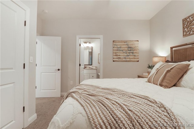 166 Captiva Dr Unit 5B, Sunrise Beach, MO 65079 - carpeted bedroom with ensuite bathroom, a sink, and baseboards