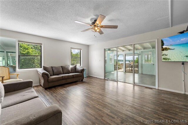 18 Trail Rd, Eldon, MO 65026 - living room with visible vents, wood finished floors, baseboards, a textured ceiling, and a ceiling fan