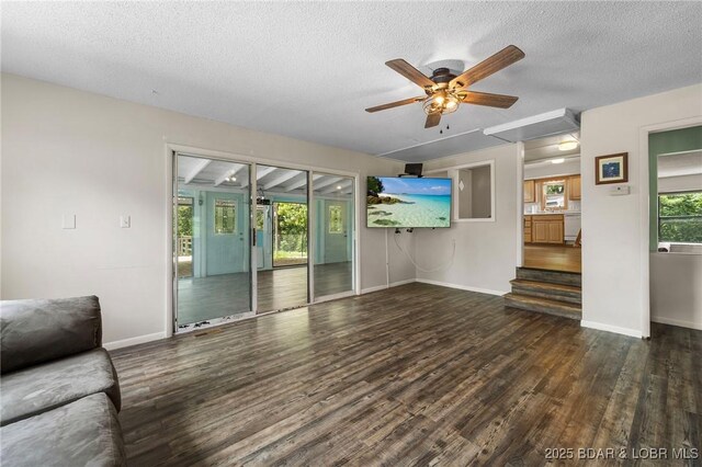 18 Trail Rd, Eldon, MO 65026 - unfurnished living room featuring a textured ceiling, a ceiling fan, baseboards, wood finished floors, and stairway