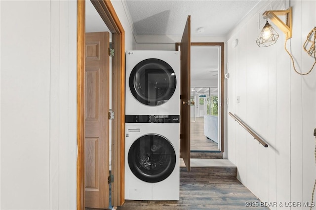 18 Trail Rd, Eldon, MO 65026 - clothes washing area with laundry area, a textured ceiling, stacked washer / dryer, crown molding, and dark wood finished floors