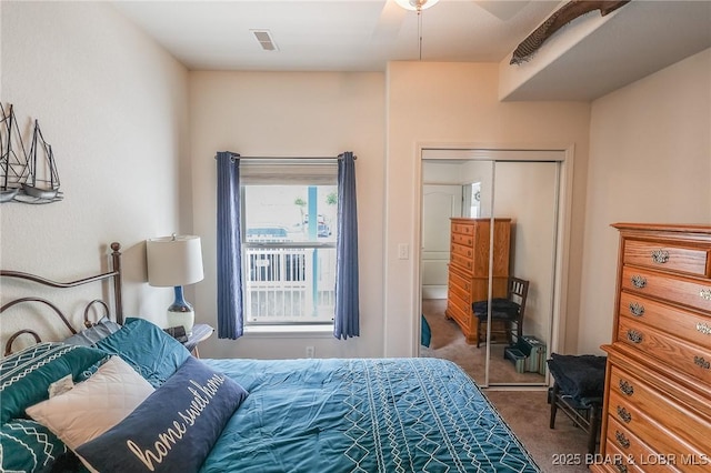 carpeted bedroom featuring a closet and visible vents