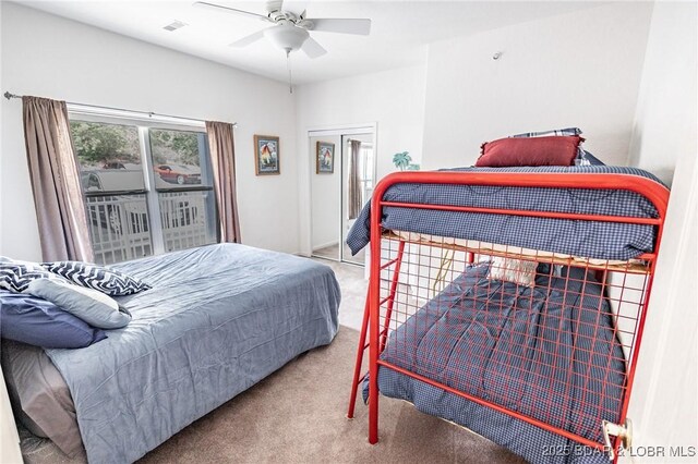 bedroom featuring carpet floors, ceiling fan, visible vents, and a closet