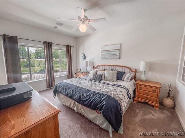 bedroom with visible vents, a ceiling fan, carpet, and baseboards