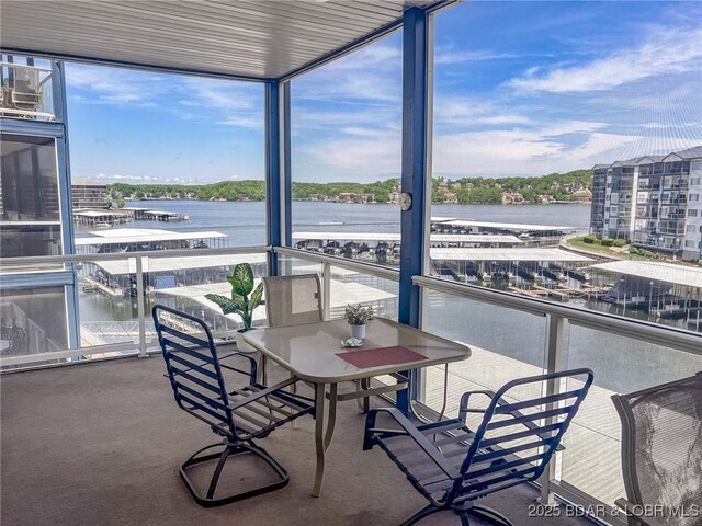sunroom / solarium with a water view