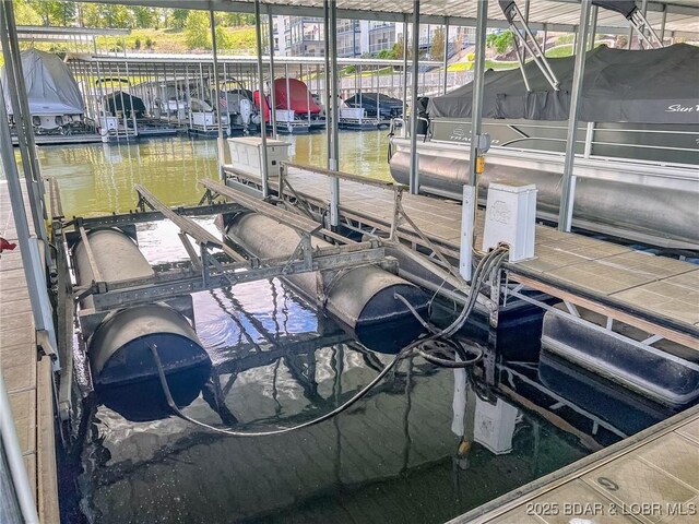 view of dock featuring a water view and boat lift