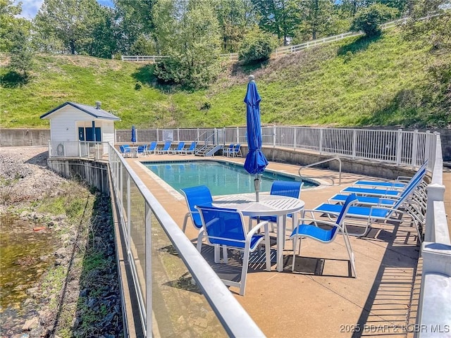 pool with fence and a patio area