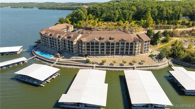 drone / aerial view featuring a water view and a forest view