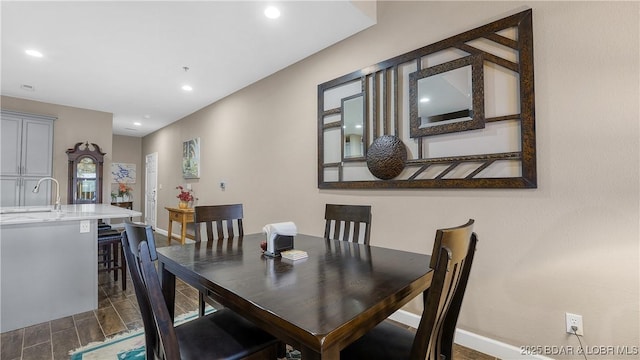 dining room with recessed lighting and baseboards