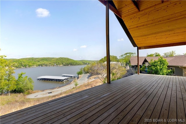wooden deck with a water view and a dock