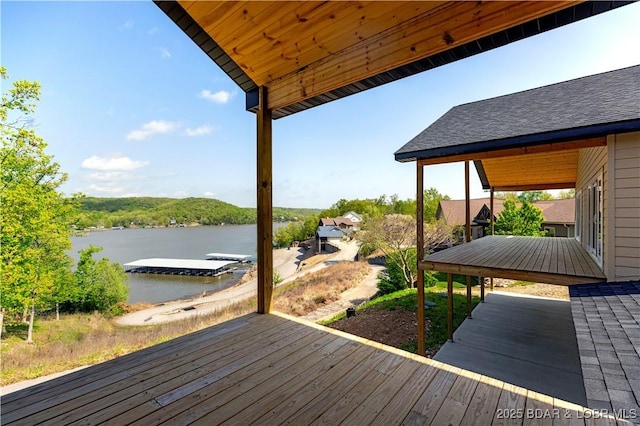 wooden terrace with a water view and a boat dock