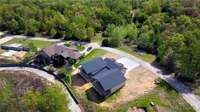 drone / aerial view featuring a view of trees